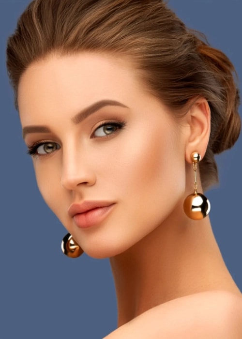 Model wearing gold plated earrings